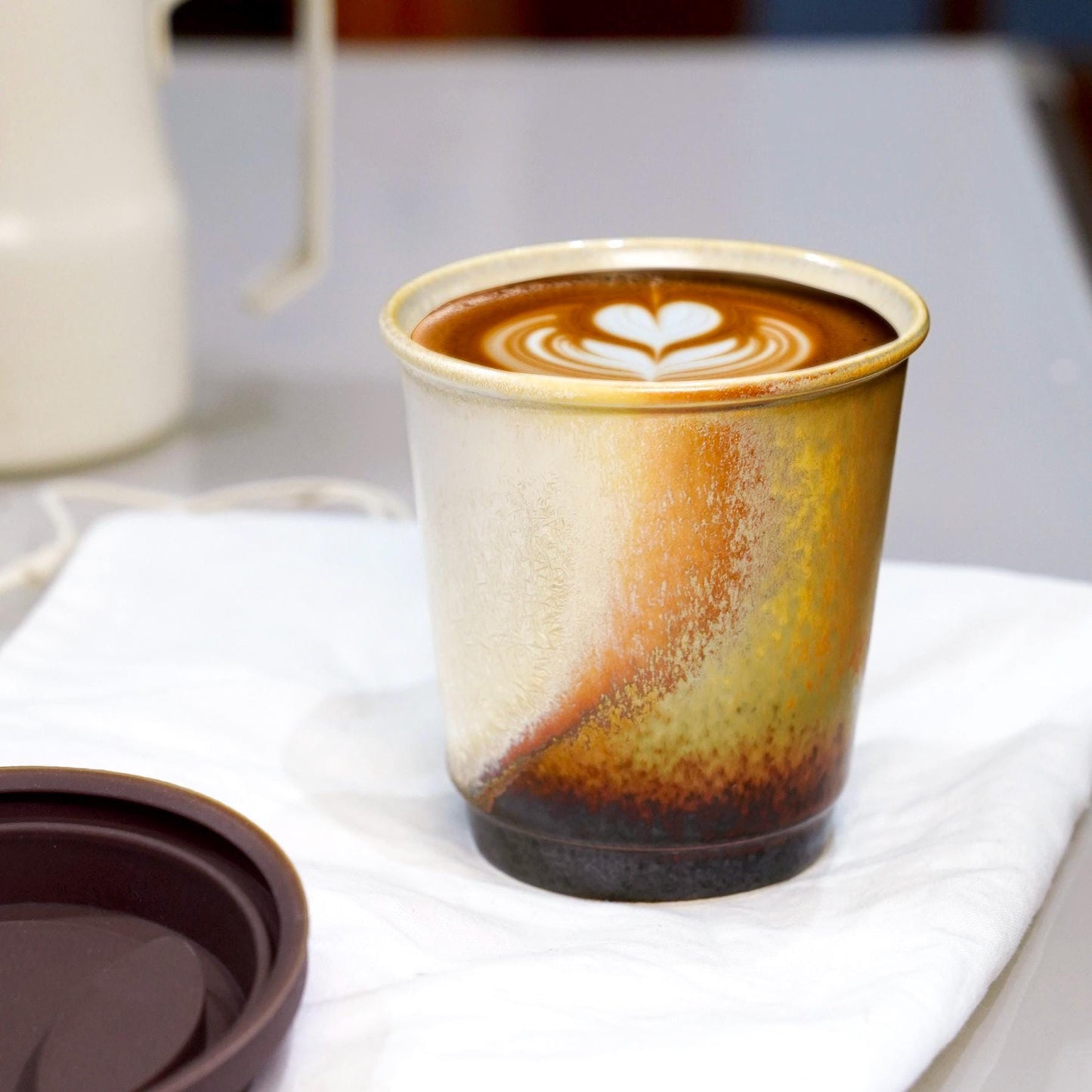 brown reusable mug with white silicone seal - Perfect for hot lattes. Leed-free ceramic, dishwasher safe.