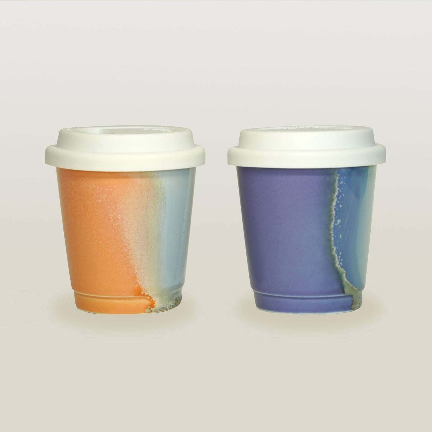 purple orange comparison reusable to-go mug with white lid - smoothies. Ergonomic grip, eco-friendly stoneware.