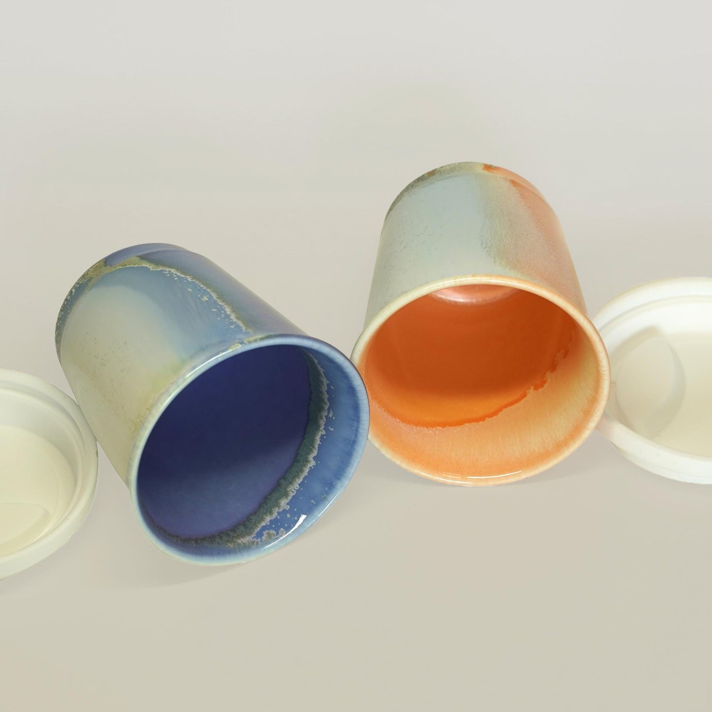 inside of purple orange comparison reusable to-go mug with white lid - smoothies. Ergonomic grip, eco-friendly stoneware.